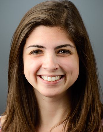 Photo of a woman with long brown hair smiling.