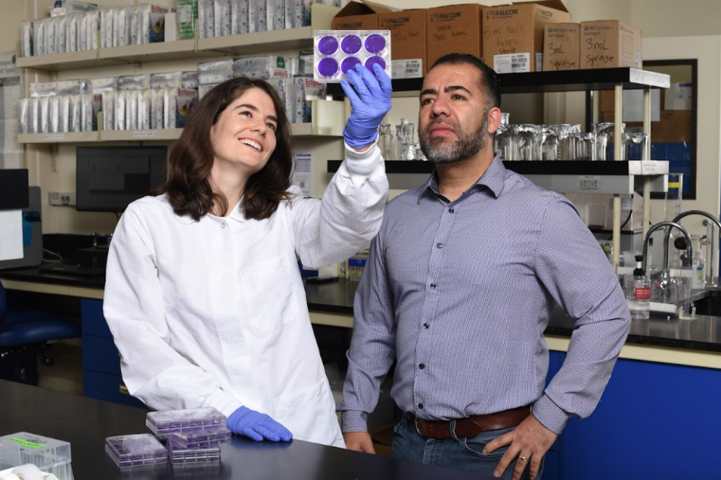 photo of grad student standing next to her faculty mentor